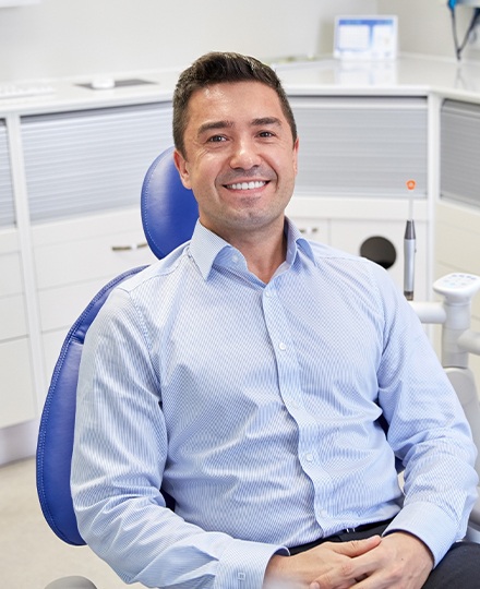Man in dental chair for preventive dentistry checkup