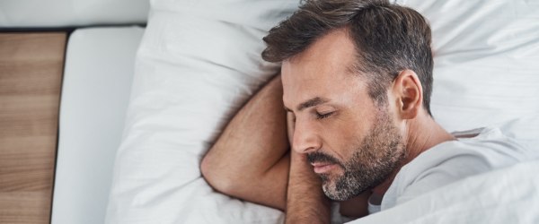 Man sleeping soundly after sleep apnea treatment